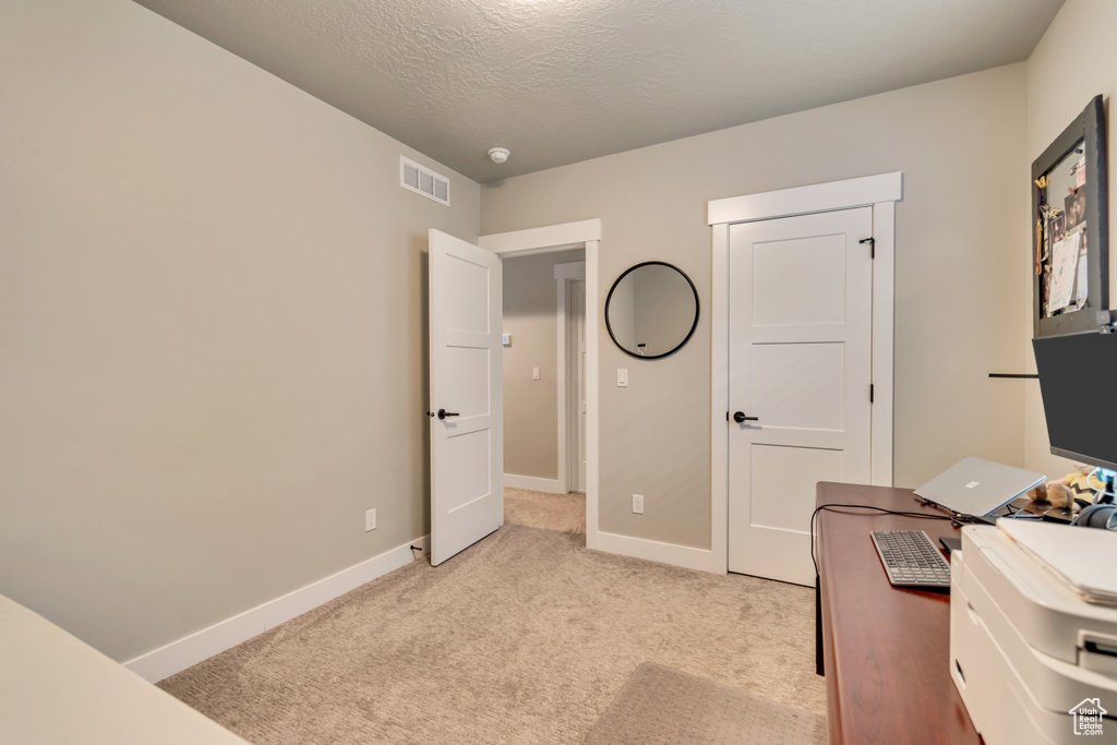 Office area with light carpet and baseboards