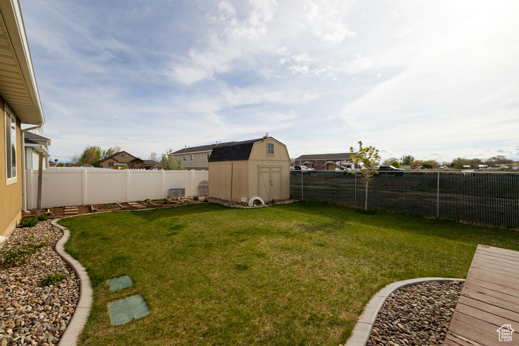 View of yard with a storage shed and an outdoor structure