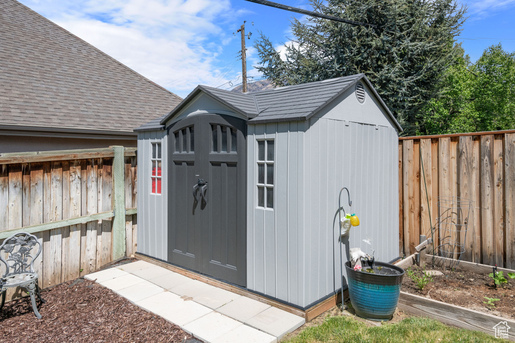 View of shed with a fenced backyard