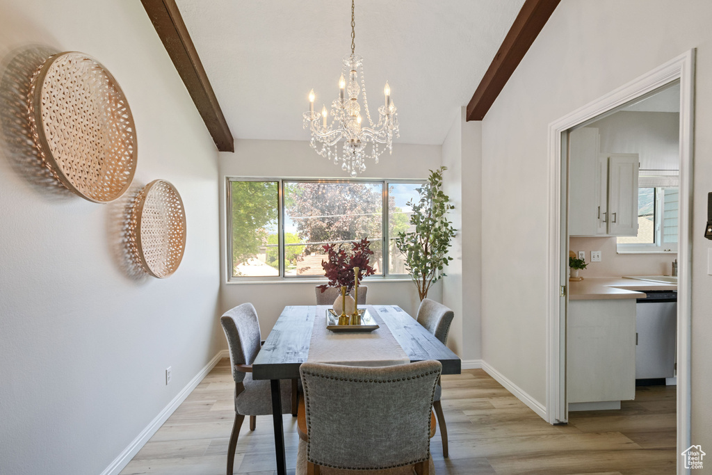 Dining area featuring a chandelier, light wood-style flooring, and baseboards