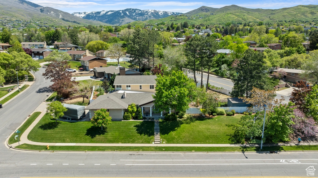 Aerial perspective of suburban area featuring a mountainous background