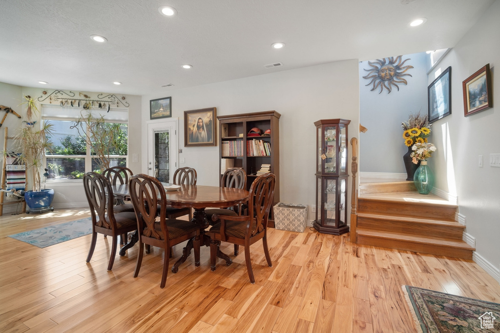 Dining area with recessed lighting, baseboards, and light wood finished floors