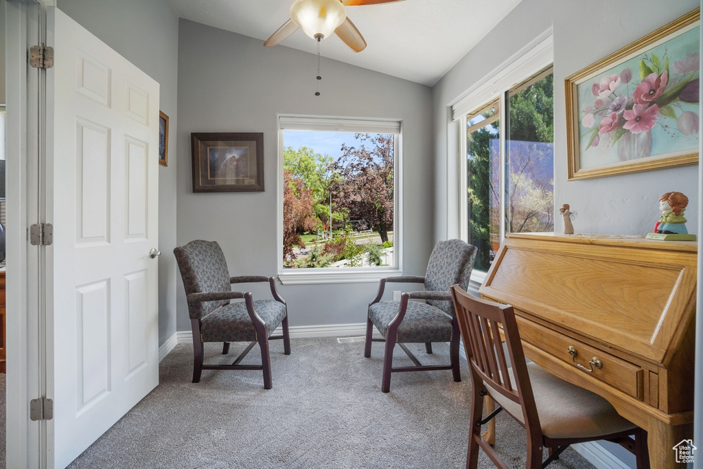 Sitting room with vaulted ceiling, carpet flooring, a ceiling fan, and baseboards