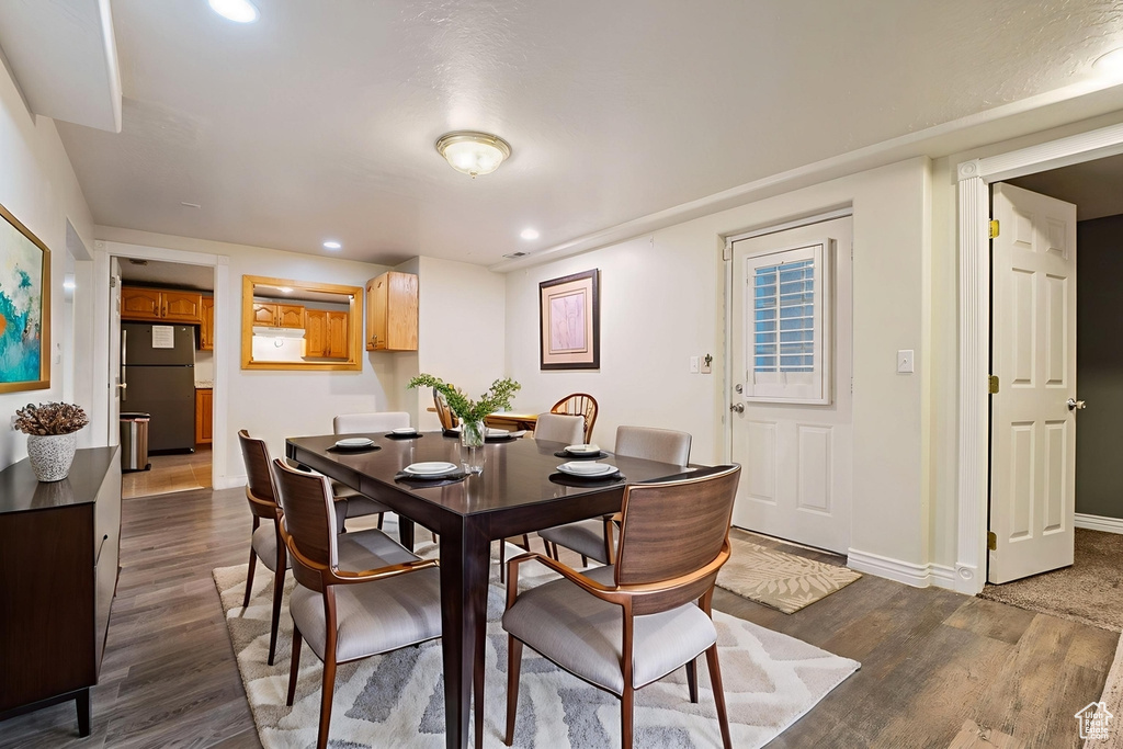 Dining space featuring dark wood-style flooring and recessed lighting