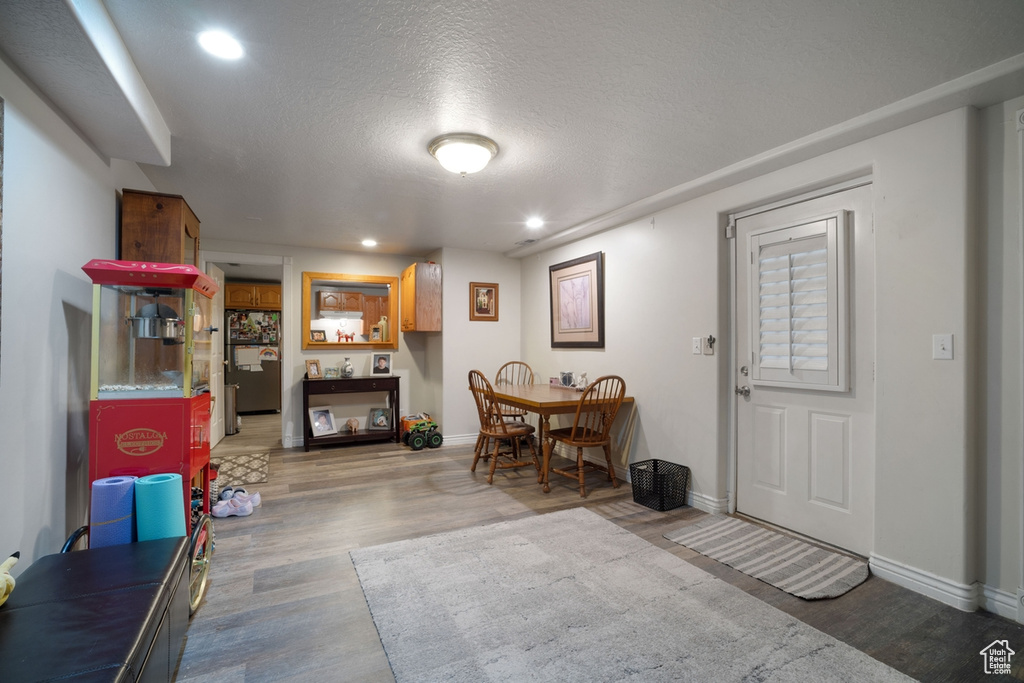 Foyer entrance with baseboards, light wood-style floors, recessed lighting, and a textured ceiling