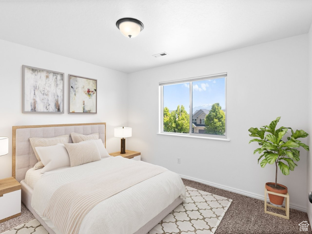 Bedroom featuring baseboards and light colored carpet