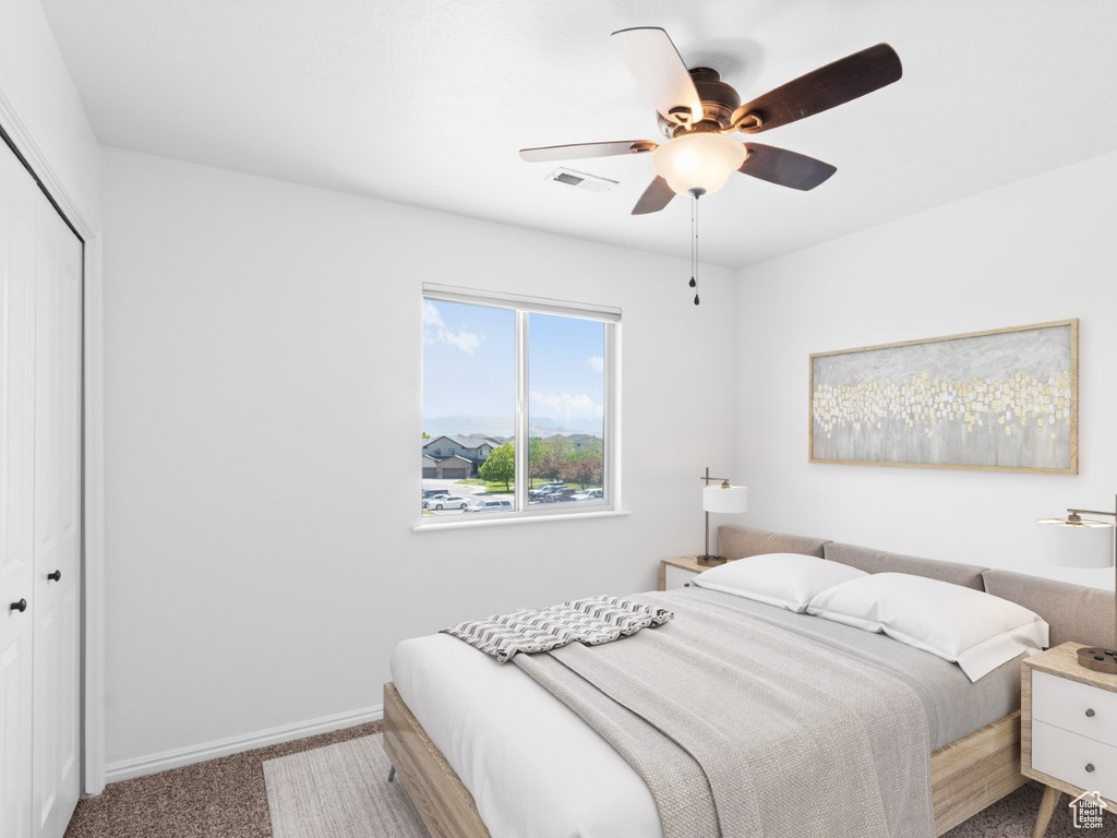 Bedroom featuring a closet, carpet flooring, baseboards, and a ceiling fan