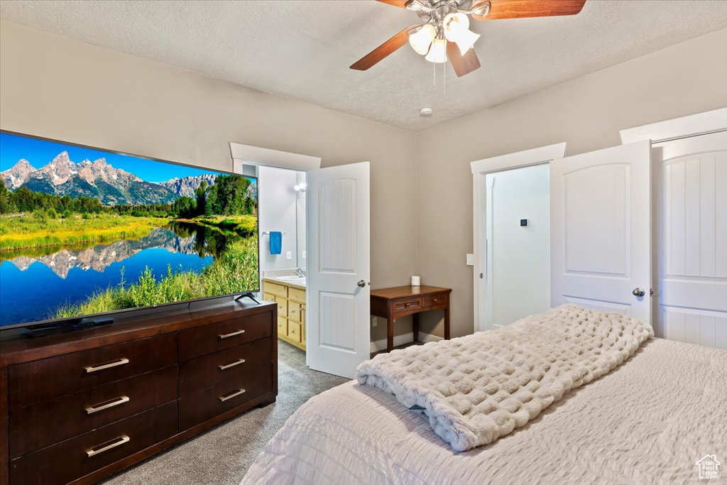 Bedroom featuring dark carpet and a ceiling fan