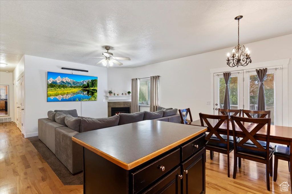Kitchen featuring light wood finished floors, a ceiling fan, and healthy amount of natural light