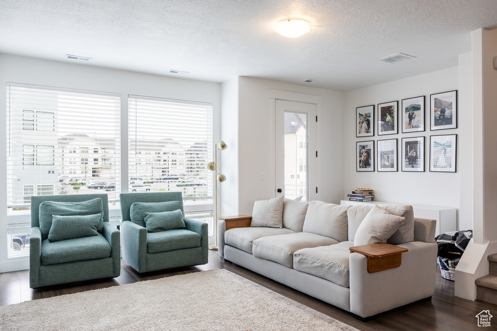 Living room with wood finished floors and a textured ceiling