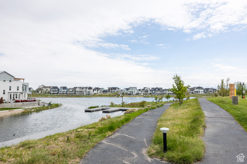 Water view with a floating dock and nearby suburban area