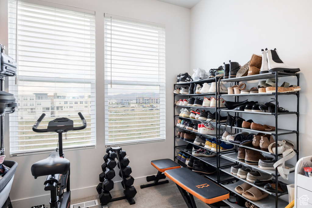 Workout area featuring carpet floors and baseboards