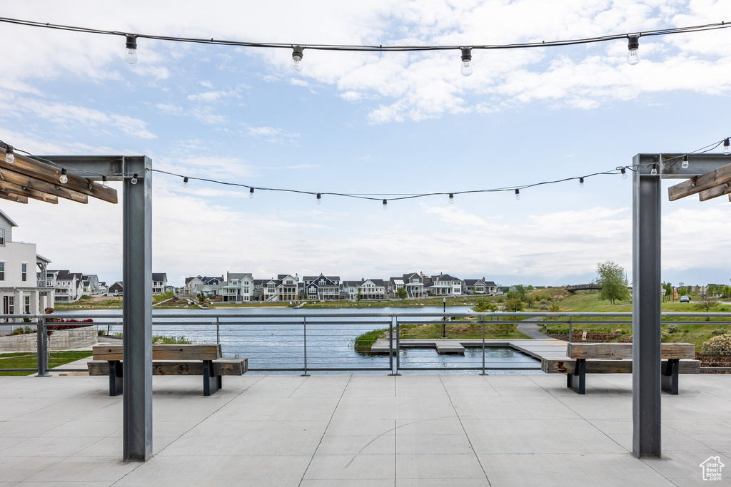 View of patio featuring a water view and a residential view