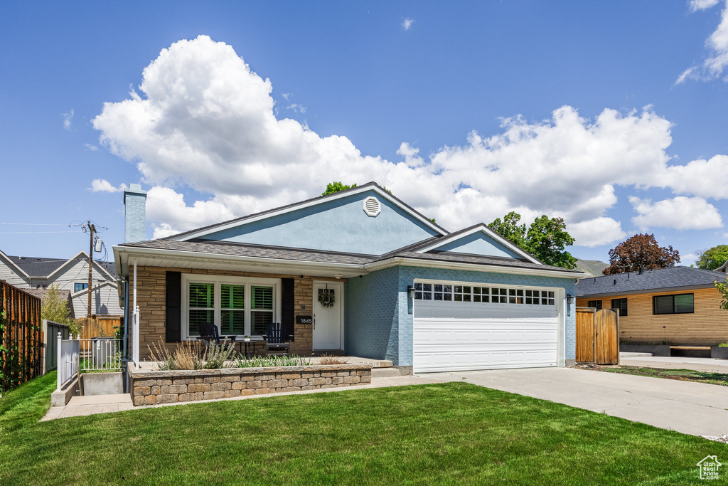 Ranch-style home featuring concrete driveway, a garage, a porch, and a chimney