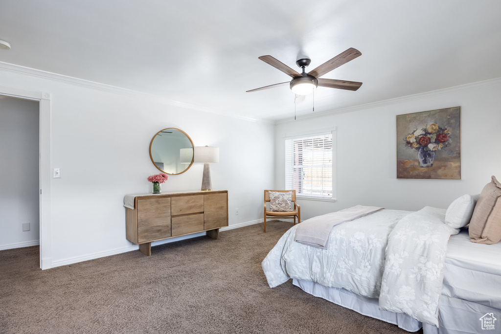 Bedroom with crown molding, carpet, baseboards, and a ceiling fan