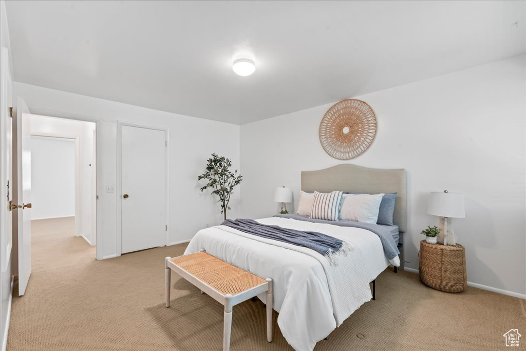 Bedroom with light colored carpet