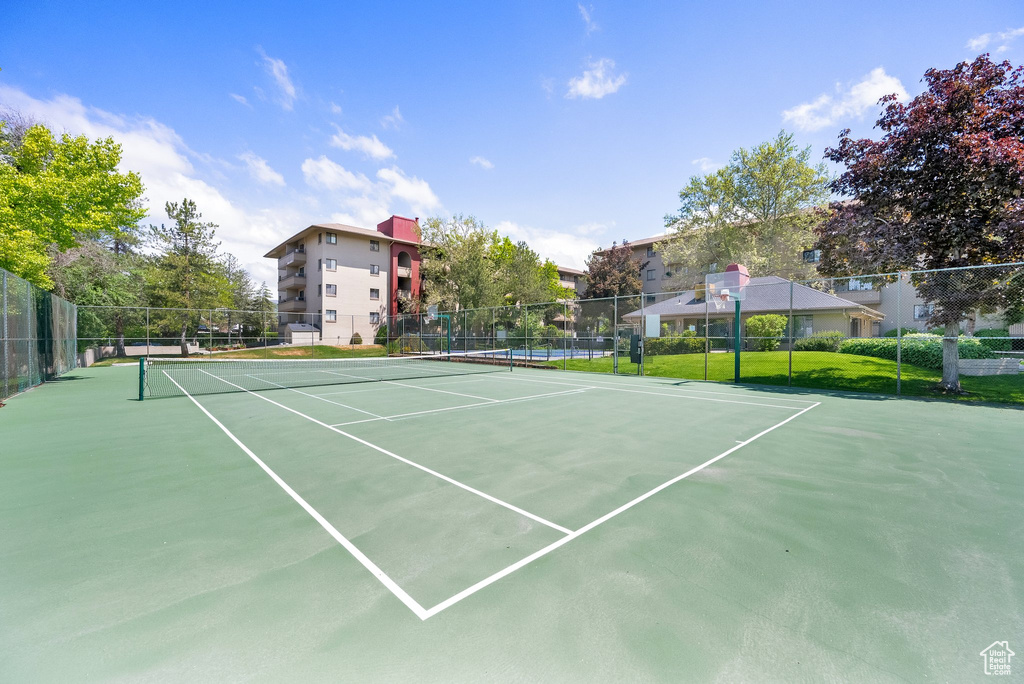 View of tennis court featuring fence
