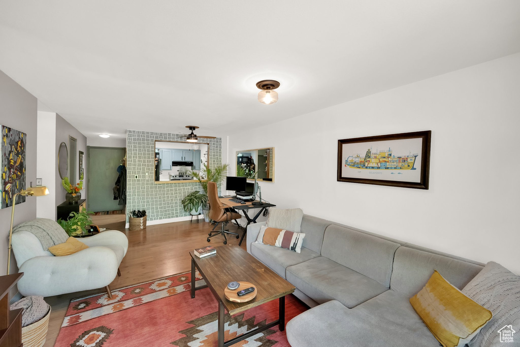 Living area with wood finished floors and a ceiling fan