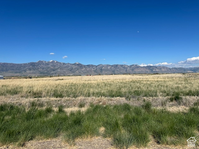 View of mountain backdrop with rural landscape