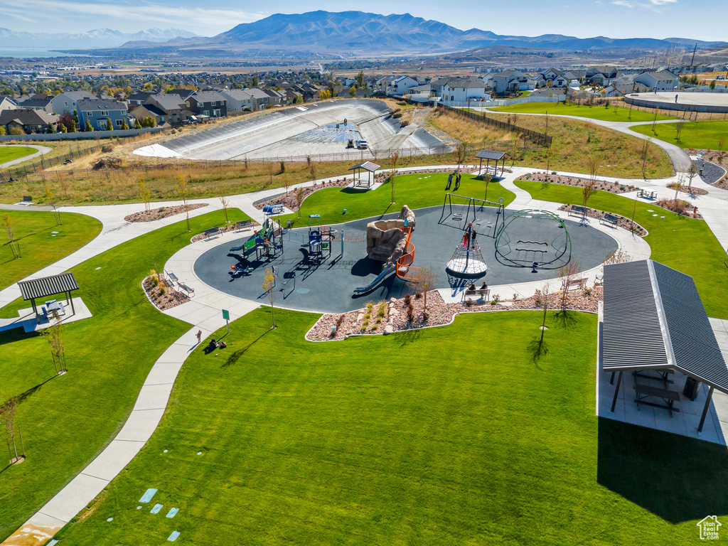 Aerial view of residential area featuring a community park and mountains