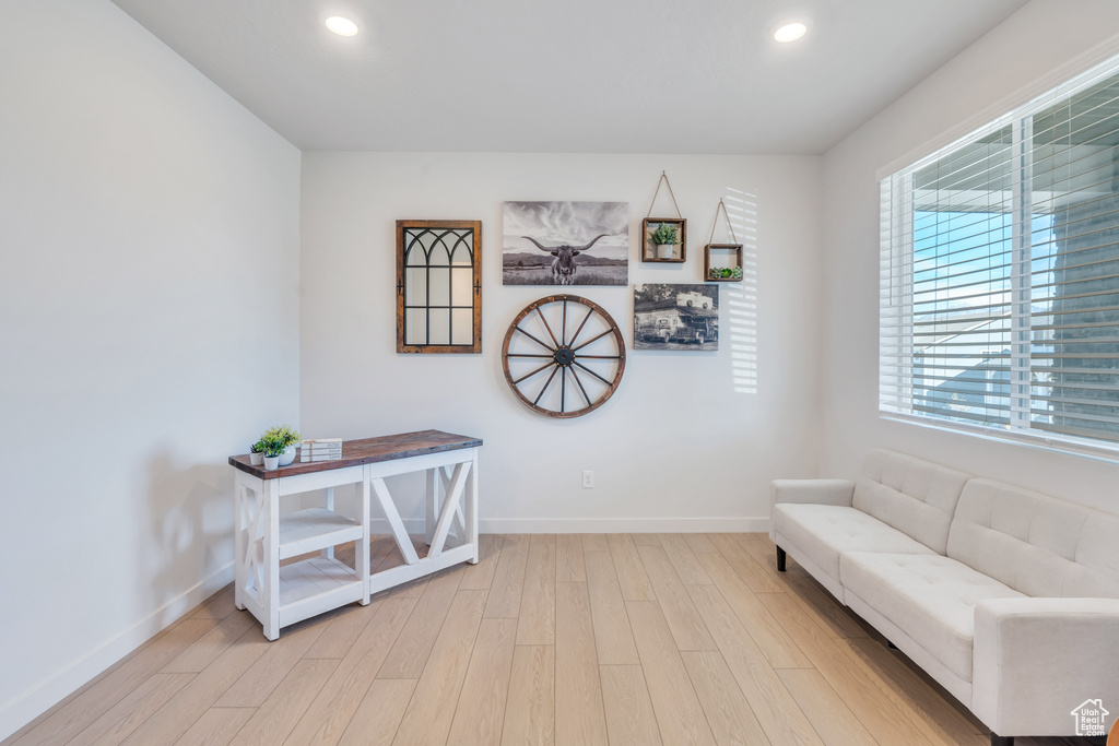 Sitting room with light wood-style floors, baseboards, and recessed lighting