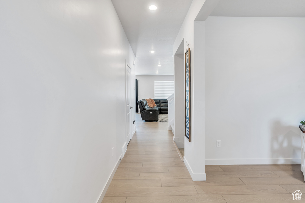 Hall featuring light wood-style floors, recessed lighting, and baseboards