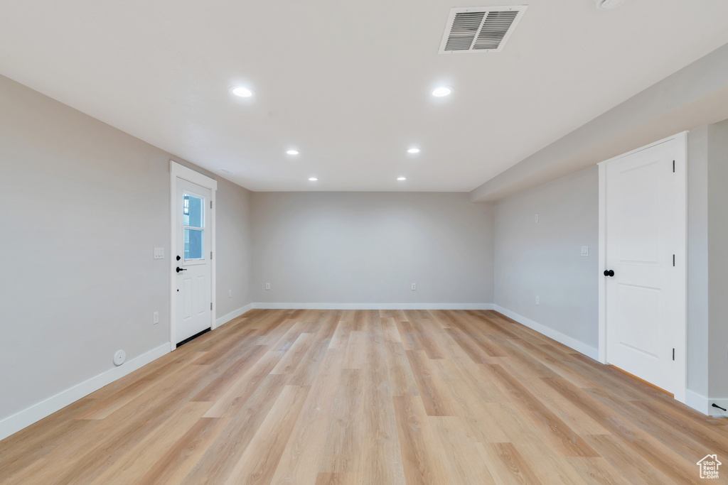 Spare room with recessed lighting, baseboards, and light wood-type flooring