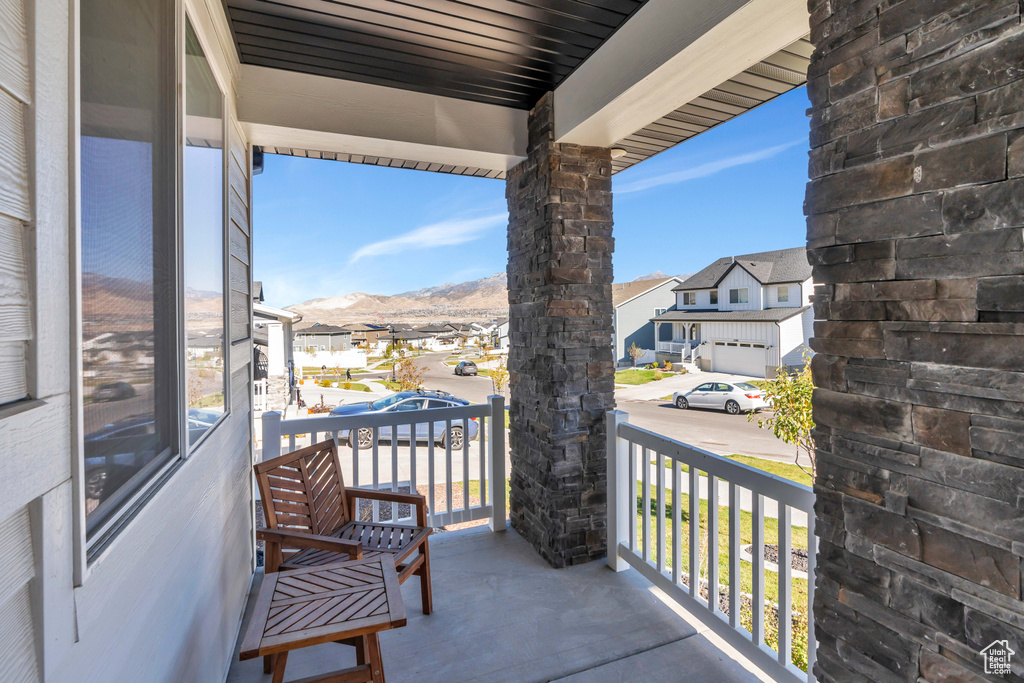 Balcony with a residential view, a porch, and a mountain view