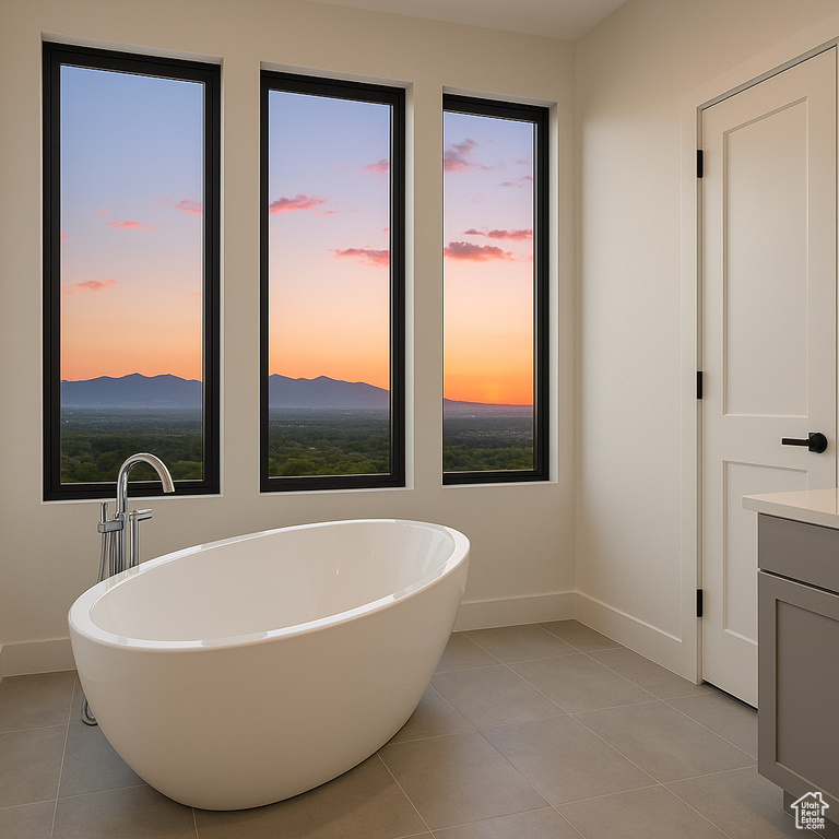 Bathroom with baseboards, tile patterned flooring, and a freestanding tub