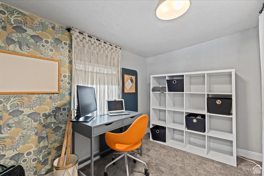Carpeted office space with baseboards