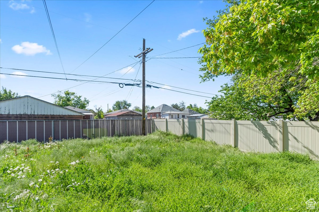 View of yard featuring fence