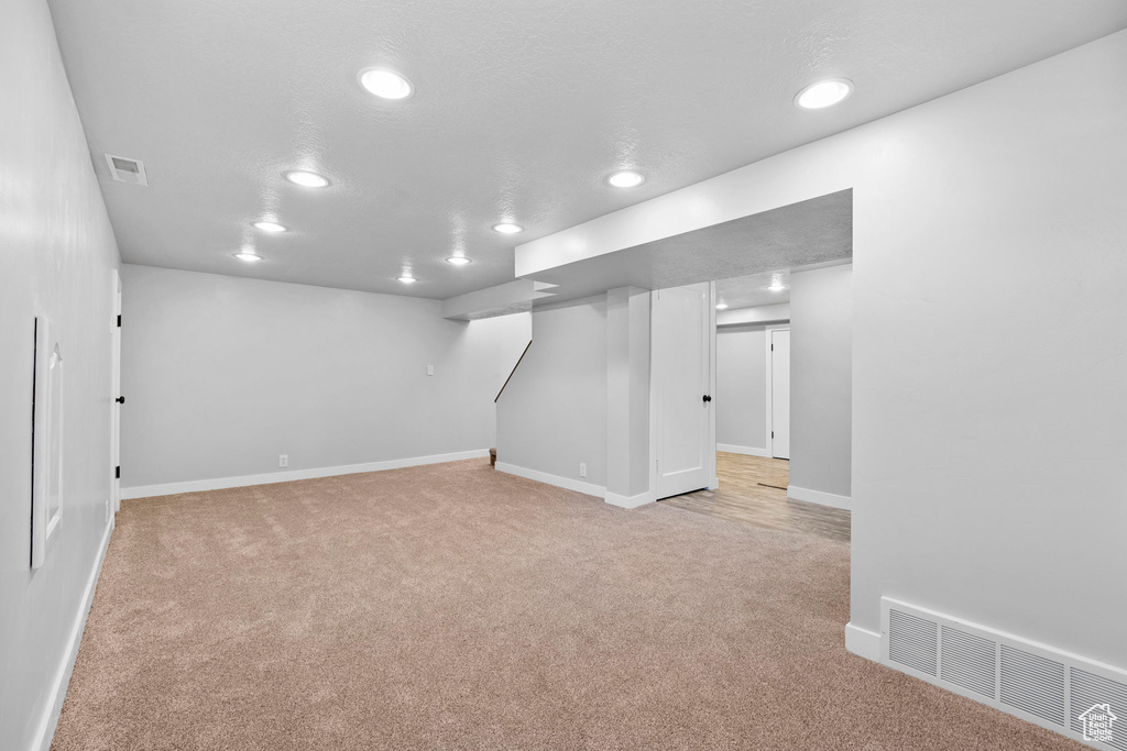 Finished basement featuring recessed lighting, light carpet, and baseboards