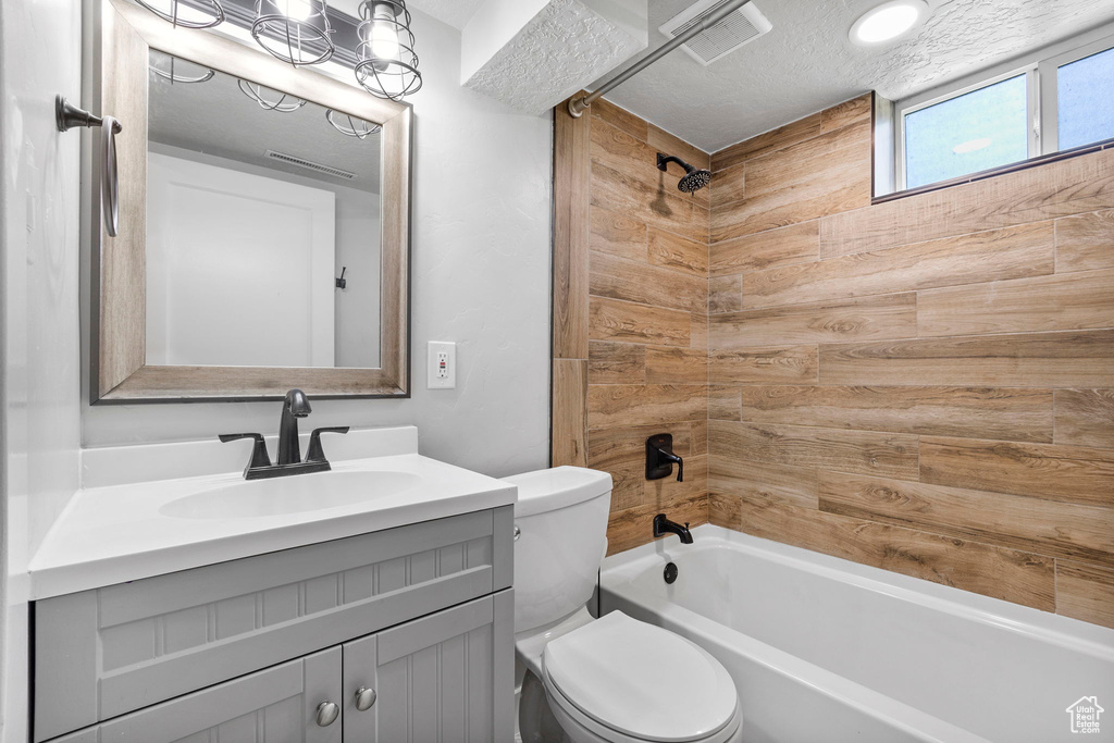 Full bath with toilet, vanity, and tub / shower combination