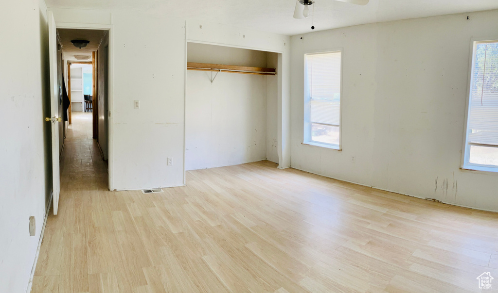 Unfurnished bedroom with light wood-style flooring and multiple windows
