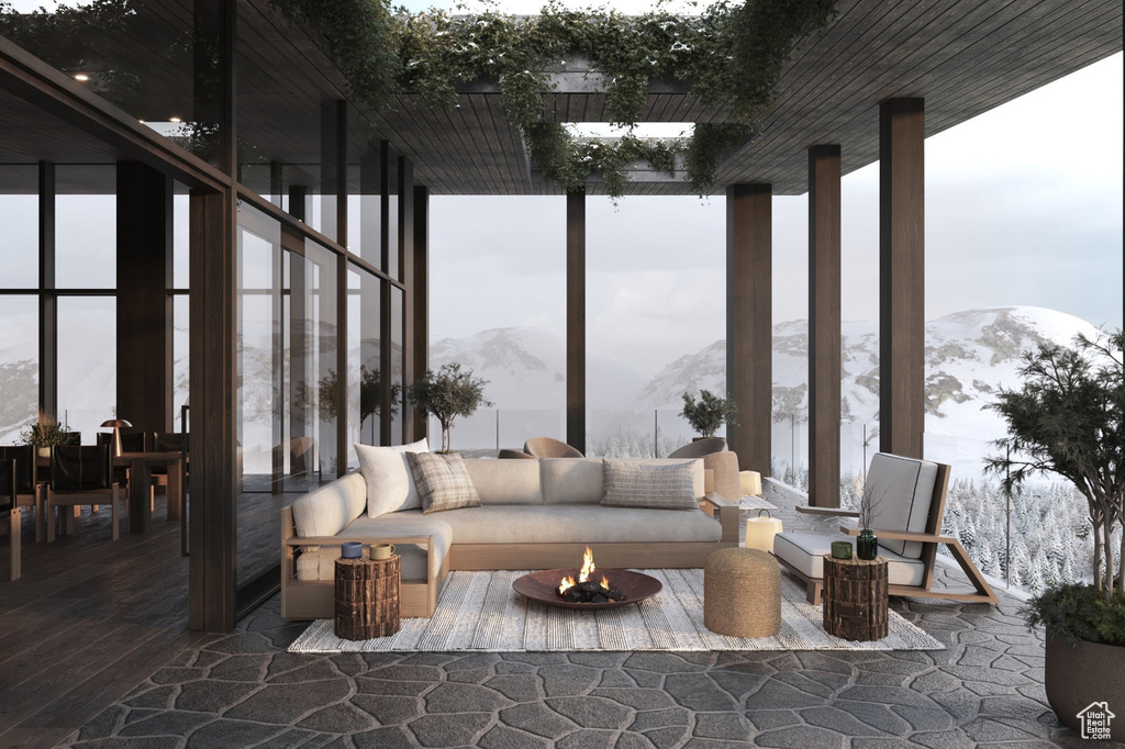 Living area featuring a mountain view, expansive windows, hardwood / wood-style floors, and plenty of natural light