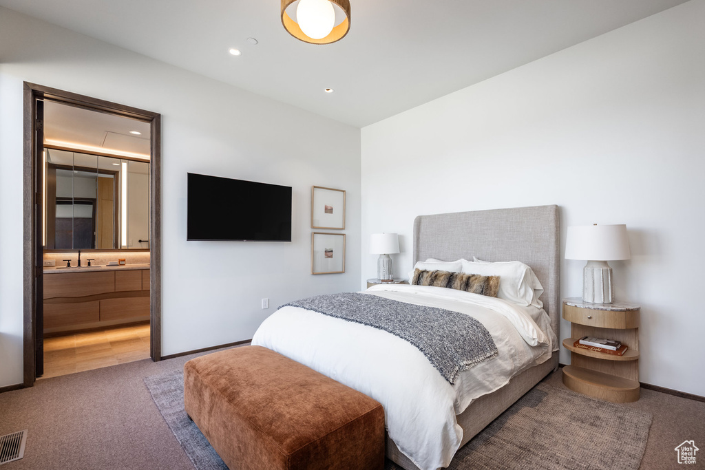 Carpeted bedroom featuring recessed lighting, connected bathroom, and baseboards