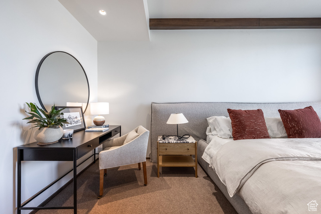 Bedroom with carpet floors, beam ceiling, and recessed lighting
