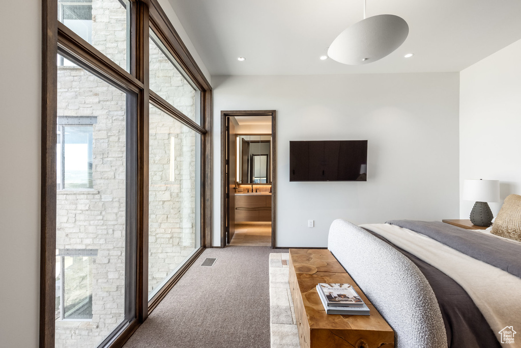 Bedroom with ensuite bath and recessed lighting