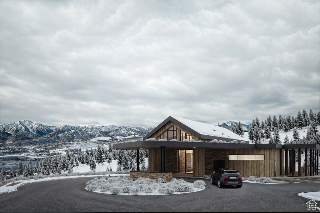 Snow covered property featuring a mountain view