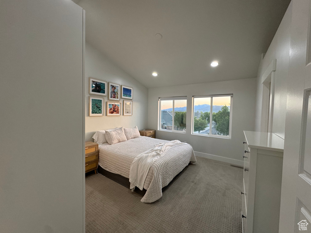 Bedroom featuring light colored carpet, recessed lighting, vaulted ceiling, and baseboards