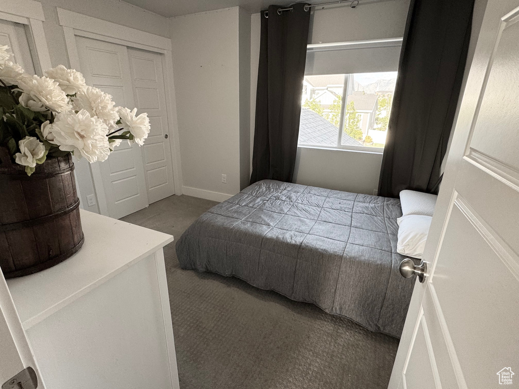 Bedroom featuring carpet floors and baseboards