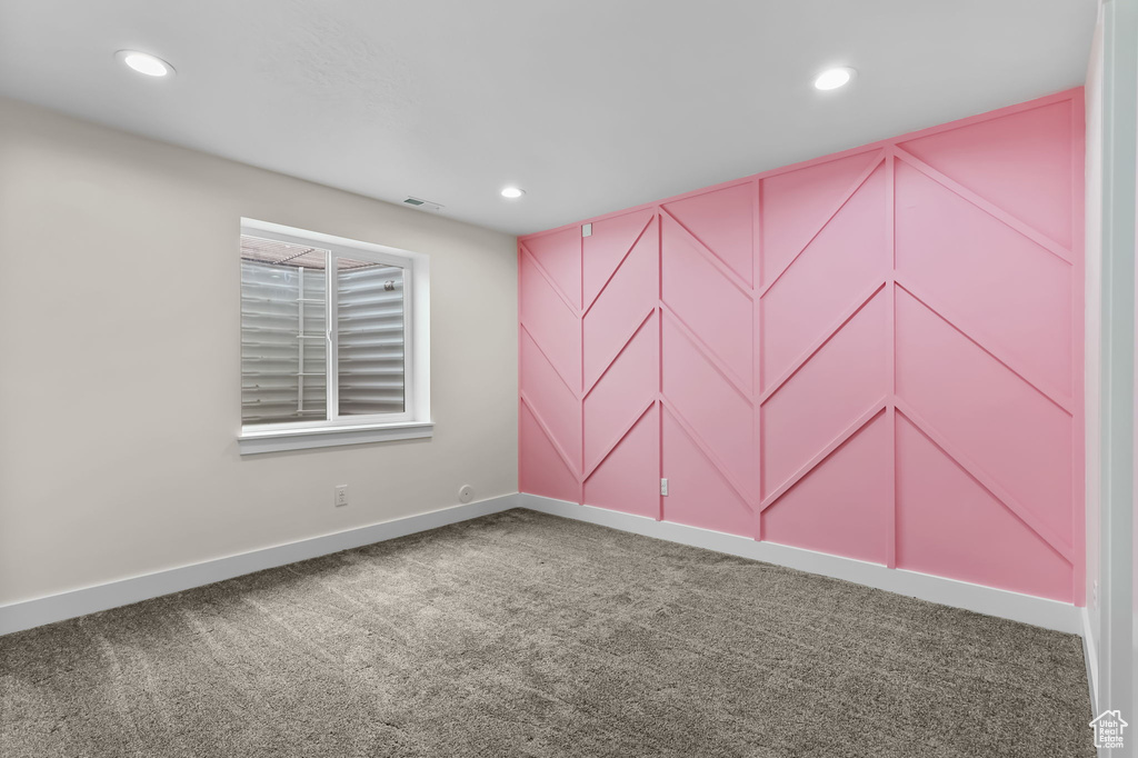 Spare room featuring carpet floors, baseboards, and recessed lighting