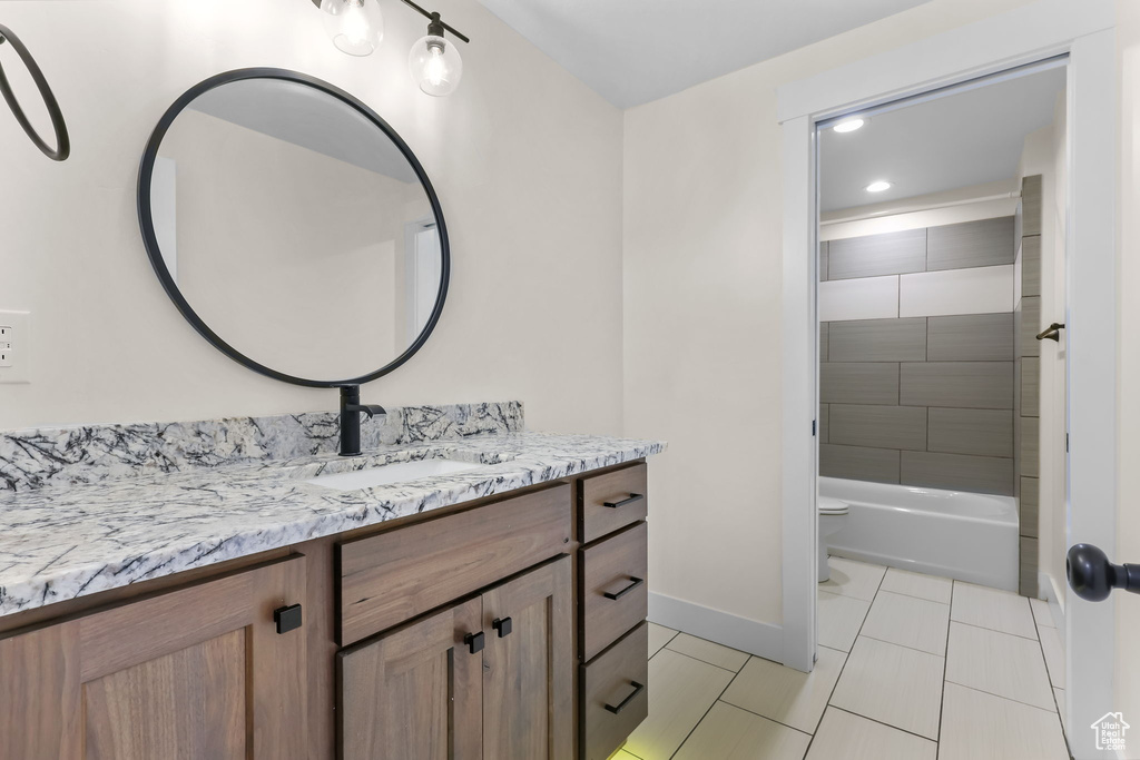 Full bath with vanity, toilet, baseboards, recessed lighting, and tile patterned floors