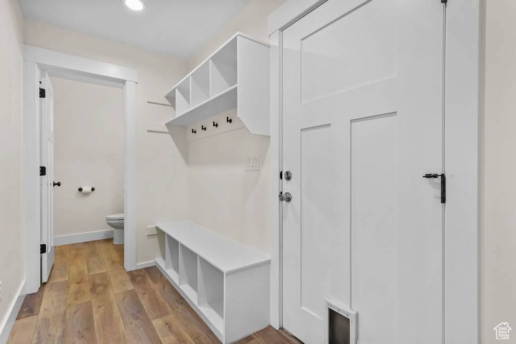 Mudroom featuring baseboards, light wood finished floors, and recessed lighting