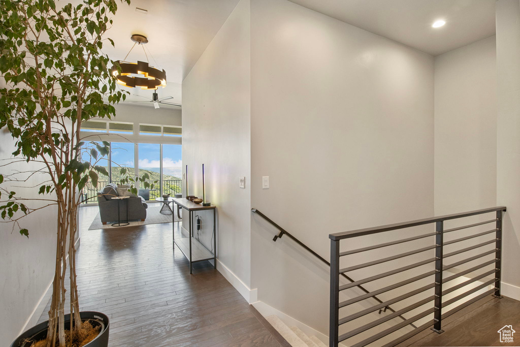 Staircase featuring ceiling fan, baseboards, wood finished floors, and recessed lighting