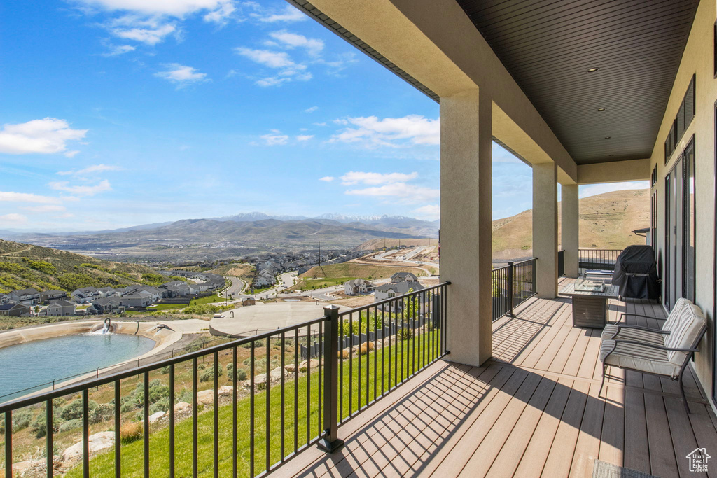 Balcony featuring view of pool area, a mountain view, and area for grilling