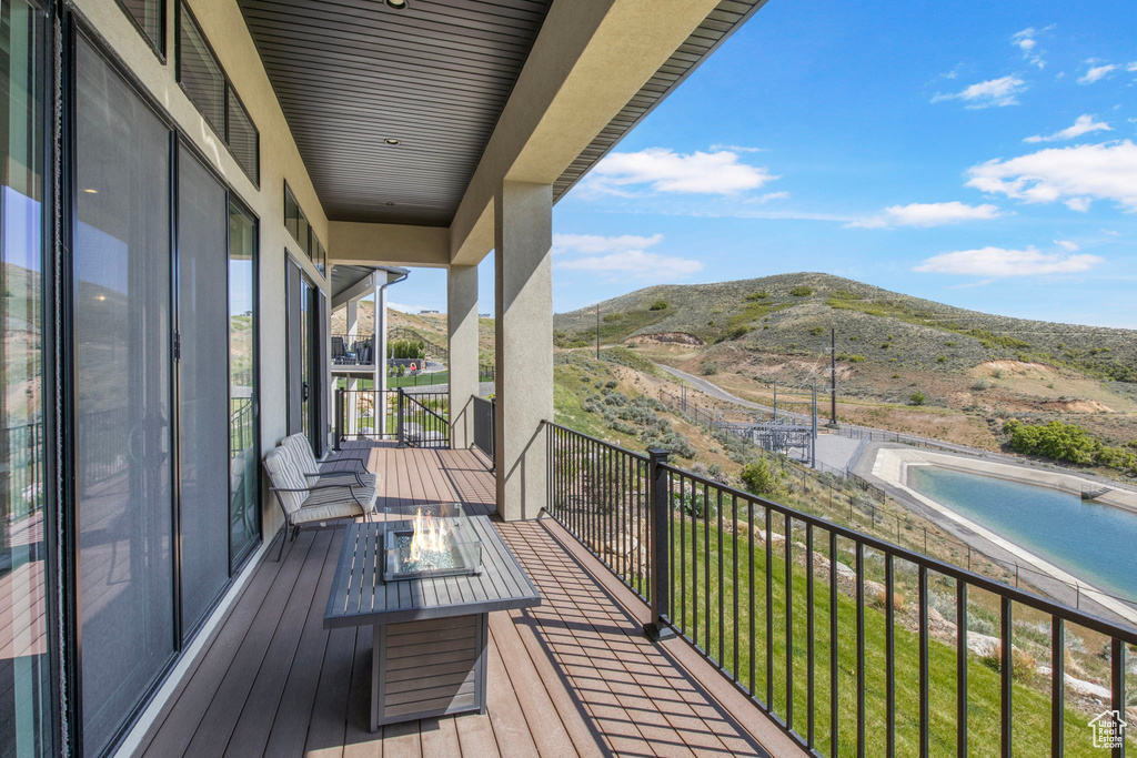 Balcony featuring an outdoor fire pit and a mountain view
