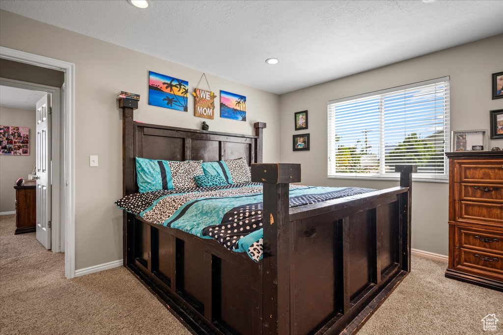 Bedroom with carpet, baseboards, and recessed lighting