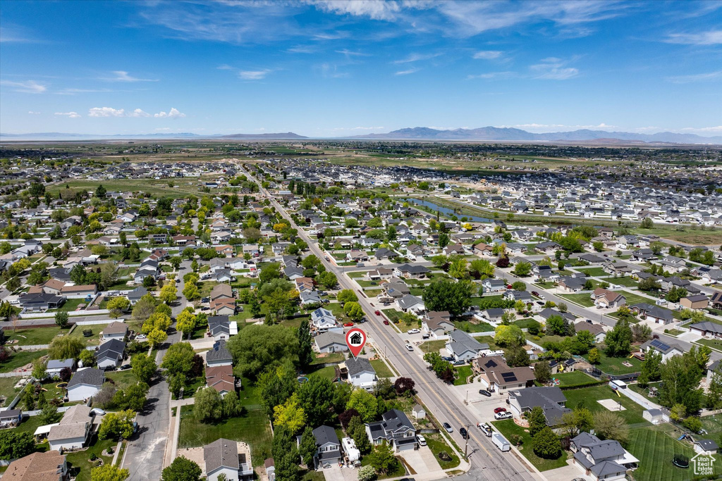 Aerial view of property's location featuring a mountainous background and nearby suburban area