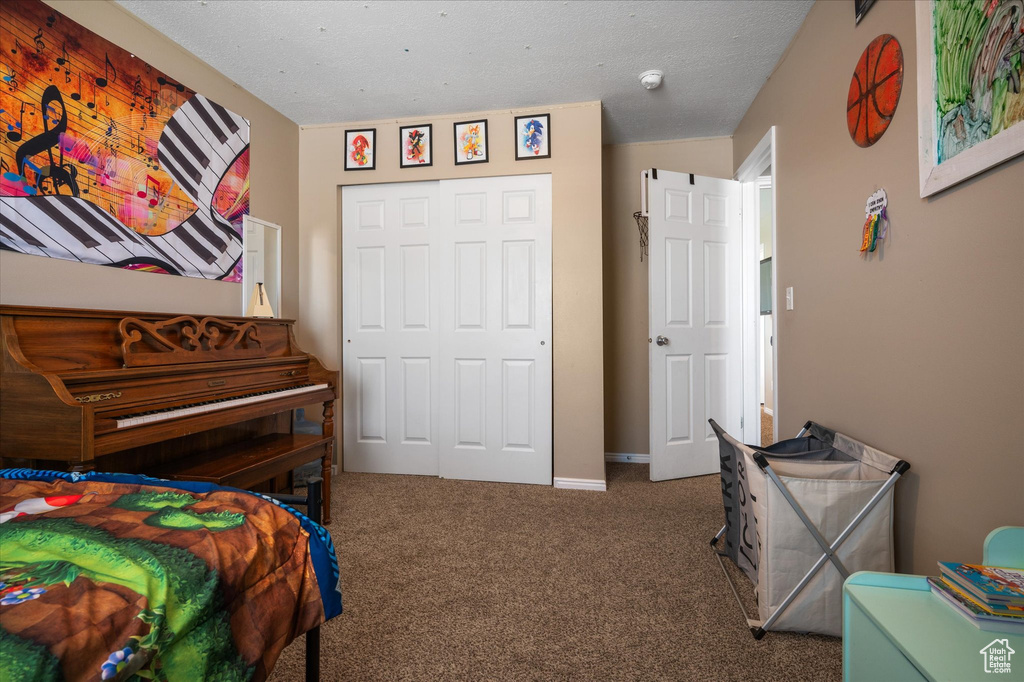 Carpeted bedroom with a closet